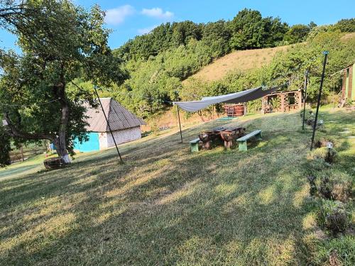 a picnic table in the middle of a field at Poiana Stelelor in Văleni