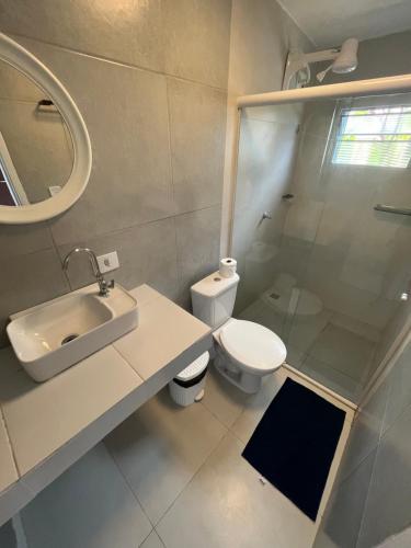 a bathroom with a toilet and a sink and a shower at Maré suites in Fernando de Noronha