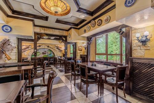 restauracja ze stołami i krzesłami w pokoju w obiekcie Edelweiss w Jaremczach
