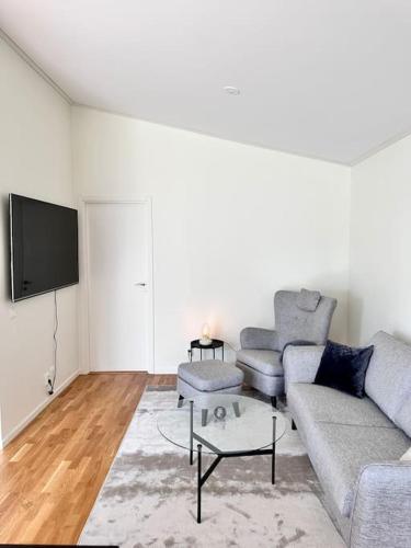 a living room with a couch and a tv at Nybyggd villa med sjönära läge in Dvärsätt