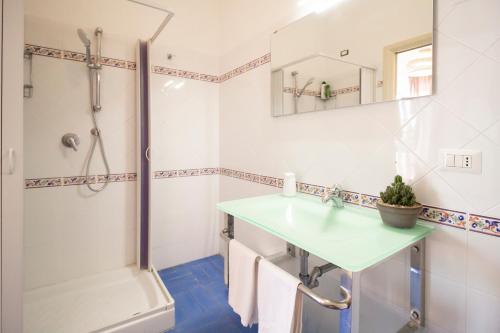 a bathroom with a sink and a shower at LA CASA DEL SOLE - Beachfront B&B - Anzio in Anzio