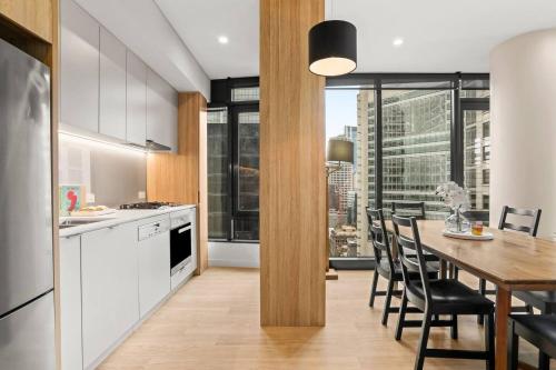 a kitchen and dining room with a table and chairs at Stylish 2 Bed in Central CBD with Pool & Gym in Sydney