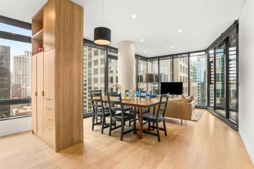 a dining room and living room with a table and chairs at Stylish 2 Bed in Central CBD with Pool & Gym in Sydney