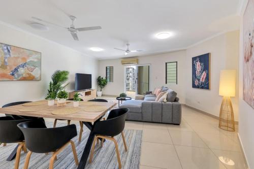 a living room with a table and a couch at Darwin CBD stunner in Darwin
