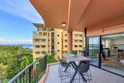 a balcony with a table and chairs on a balcony at Stylish, Stunning and Sunrise Trifecta in Darwin