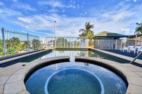 a swimming pool in the middle of a yard at Watch the Sun set over Cullen Bay Marina and Harbour in Larrakeyah