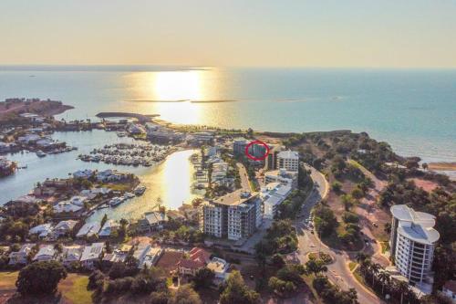 an aerial view of a resort near the ocean at Watch the Sun set over Cullen Bay Marina and Harbour in Larrakeyah