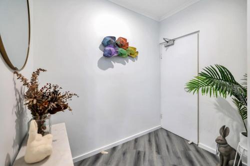 ein Raum mit weißen Wänden und einem Tisch mit Blumen an der Wand in der Unterkunft 2 Bedroom Top Floor Parap Delight New to Market in Parap