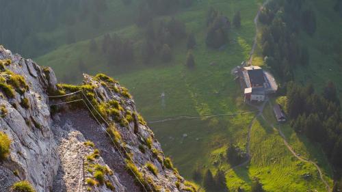 a train on the side of a mountain at Berggasthaus Holzegg - Accessible Only by Cable Car in Alpthal