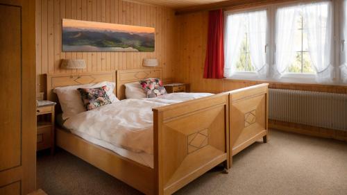 a bedroom with a large bed in a room at Berggasthaus Holzegg - Accessible Only by Cable Car in Alpthal