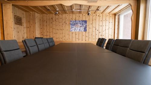 a conference room with a long table and chairs at Berggasthaus Holzegg - Accessible Only by Cable Car in Alpthal