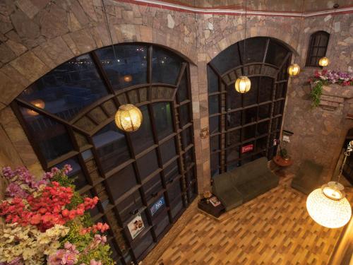 an overhead view of a room with doors and flowers at Devi Enterprises - Hotel Khems in Ooty