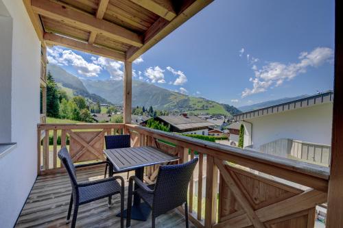 a balcony with a table and chairs and mountains at Residenz an der Burg by Kaprun Rentals in Kaprun