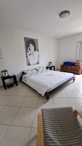 a bedroom with a bed and a picture of a woman at Casa Ofelia in Colledimezzo