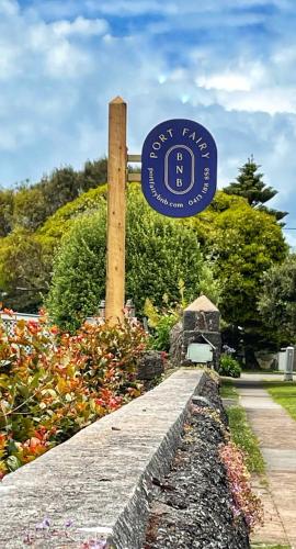 a sign for a guest park in a garden at Port Fairy BNB - The Yellow Suite in Port Fairy