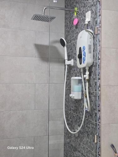 a shower with a blow dryer in a bathroom at The Shore SeaView Center Kota Kinabalu Home Suites Studio in Kota Kinabalu