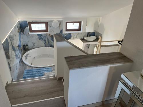 a small bathroom with a tub and a sink at Sebe apartments 4 in Holíč