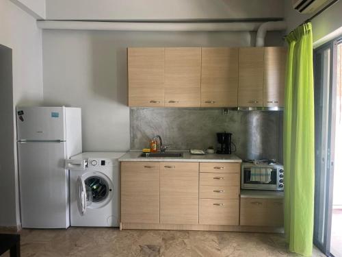 a kitchen with a refrigerator and a washing machine at Studios Μιχαλαρεα in Kyparissia