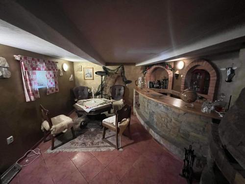 a living room with a stone wall and a table and chairs at Sebe apartments 4 in Holíč
