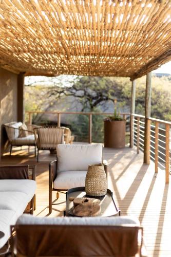 a patio with a couch and chairs on a deck at Nambiti Hills in Nambiti Private Game Reserve