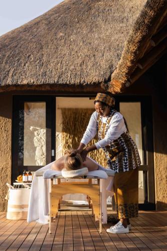 a woman getting her hair cut on a table at Nambiti Hills in Nambiti Private Game Reserve