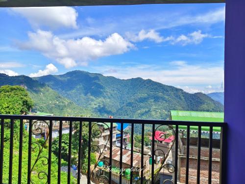 a balcony with a view of a mountain at SHARTHI HOMESTAY AND LODGING in Namchi