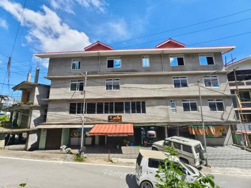 a large building on the corner of a street at SHARTHI HOMESTAY AND LODGING in Namchi