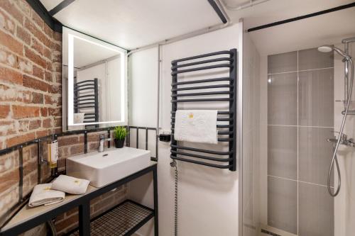 a bathroom with a sink and a shower at Royal mini apart-hotel on Kovzhyna in Lviv