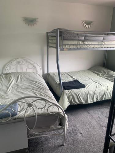 a bedroom with two bunk beds in it at 3 Bedroom Home in the Dale’s, Very close to Ipswich town centre. in Whitton