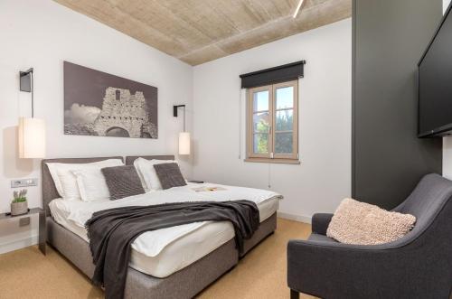 a bedroom with a large bed and a chair at Villa Calma in Šivati