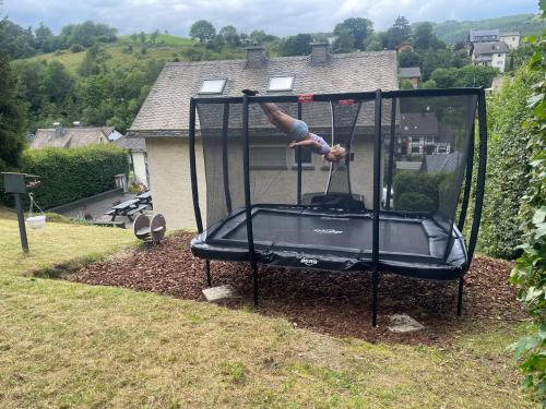 a person on a trampoline in a yard at Hausamaarbach in Willingen