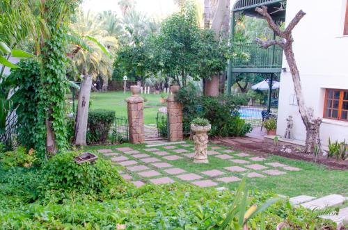 a garden with a fire hydrant in the middle of a yard at Green Gables Guest House in Upington