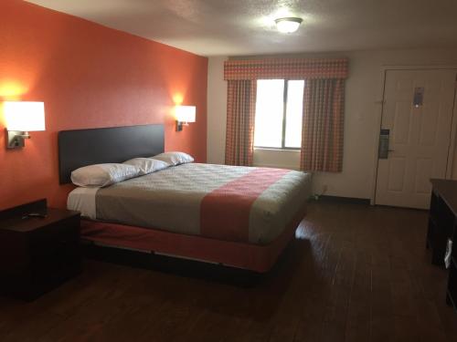 a hotel room with a bed and a window at Motel 6-Waco, TX in Waco