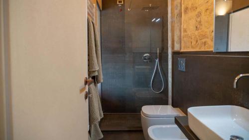a bathroom with a shower and a toilet and a sink at DONNAPAOLA MODERN FARM in Altamura