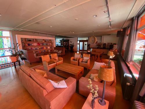 an overhead view of a living room with couches and tables at Het Huis van Bewustzijn in Limmen