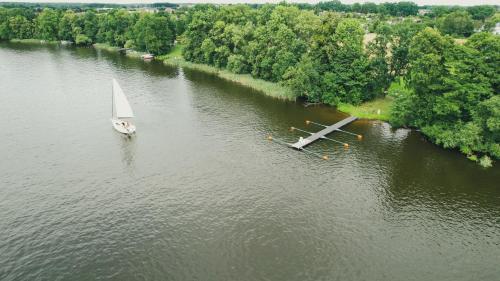 an airplane and a sail boat in the water at MAŁY PORT-Iława - Jezioro - Plaża - Marina priv - 5 pokoi VIP - czysto na 10 in Iława
