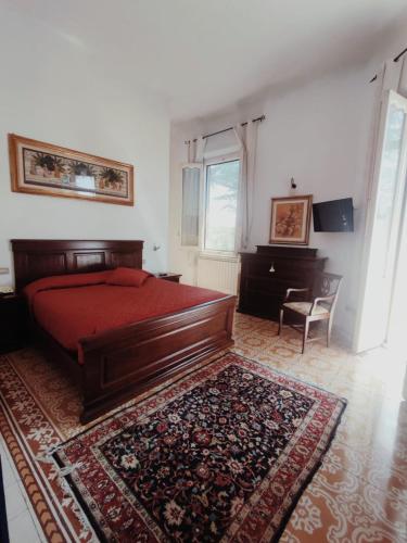 a bedroom with a red bed and a rug at Villa Al Piano in Lastra a Signa