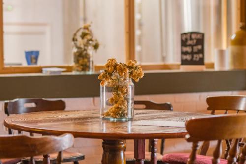 a vase of dried flowers sitting on a table at Ernest by Bloom Stays in Tenterden