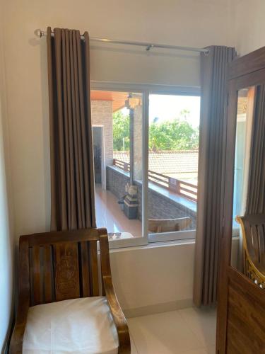 a room with a window with a view of a porch at Manis Guest House in Seminyak