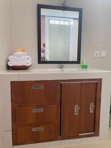a bathroom with a sink and a mirror at Manis Guest House in Seminyak