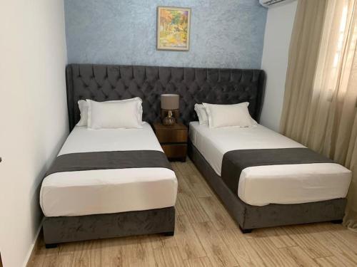 two beds in a small room with two beds sidx sidx sidx at Tibouda House Studio Deluxe Cap De L'eau in Ras El Ma