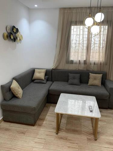 a living room with a couch and a coffee table at Tibouda House Studio Deluxe Cap De L'eau in Ras El Ma