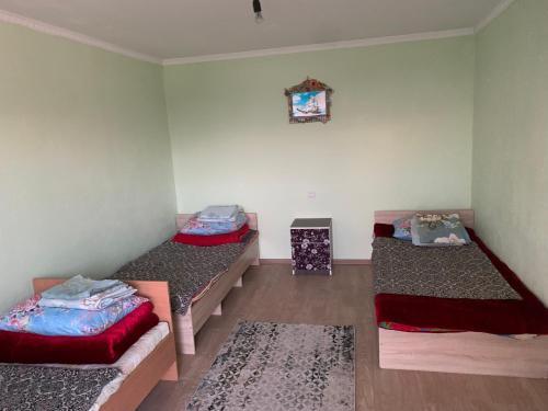 a room with two beds in a room at Гостевой дом in Cholpon-Ata