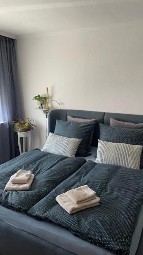 a blue bed with two towels on top of it at Ferienwohnung Weitsicht in Hüttenrode