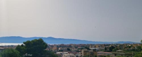 a view of a city with mountains in the background at Nuccia'S House in Reggio Calabria