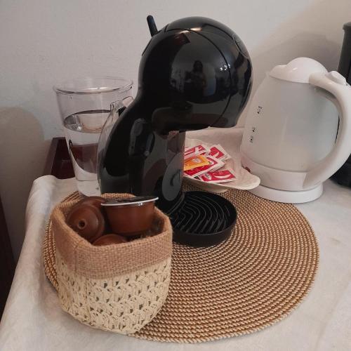 a coffee maker and a basket of donuts on a table at Il vecchio frantoio in Panicale