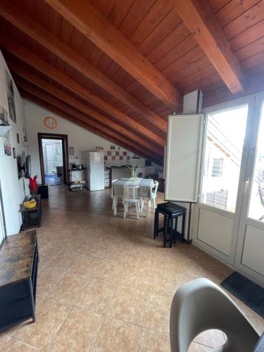 a large living room with a table and a kitchen at Messina Skyline in Messina