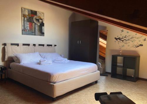 a bedroom with a large bed and a fireplace at Messina Skyline in Messina