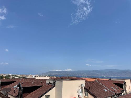 a view of roofs of buildings and the ocean at Messina Skyline in Messina