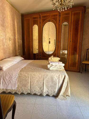 a bedroom with a bed and two windows at Appartamento centro storico quartiere San Michele in Sciacca